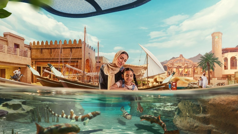 Mother and daughter enjoying the touch pool at Abu Dhabi Ocean