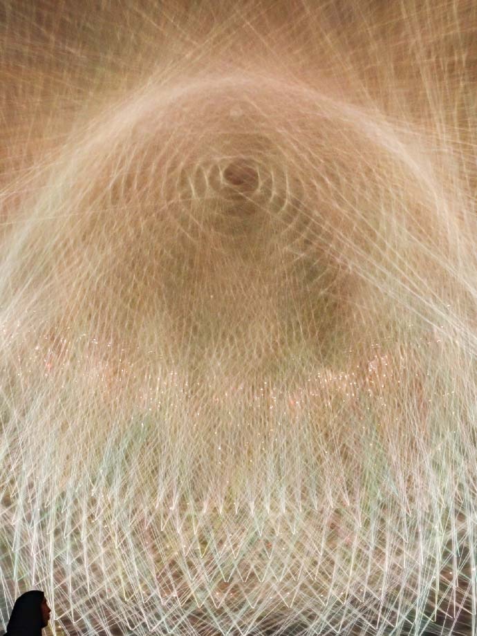 Yellowish white ray of laser light from Light Vortex artwork