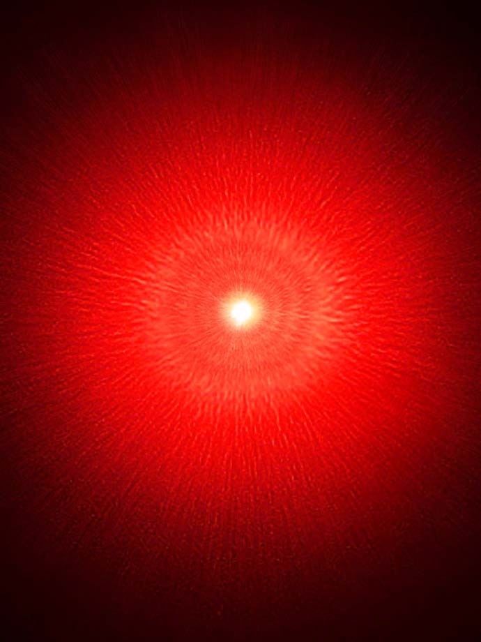 A red glow with light streaks resonating from Solidified Sparks artwork