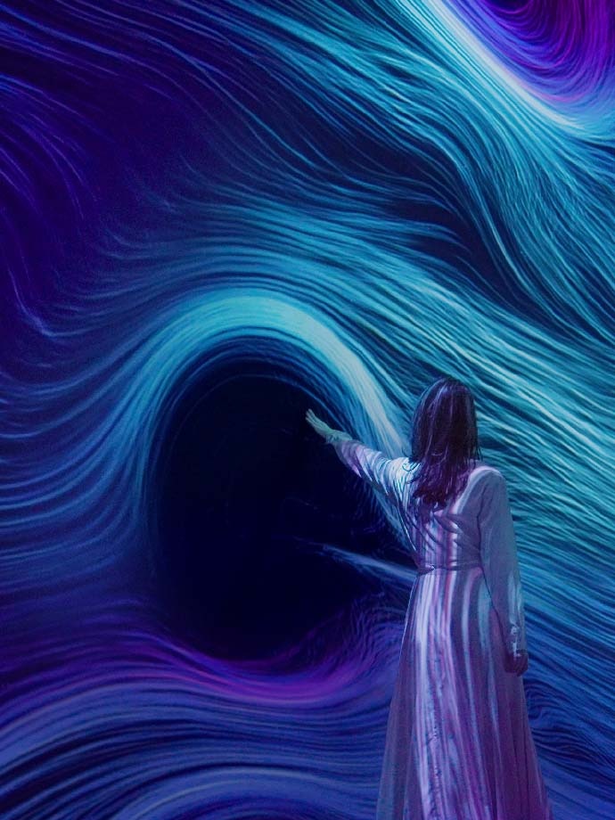 A lady interacting with Wind Form artwork